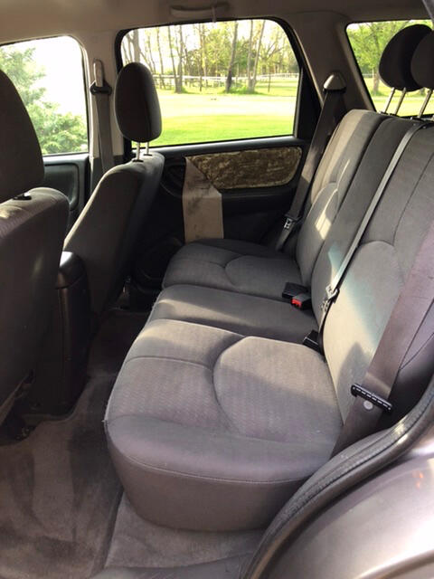 Back seat, loose vinyl on door visible